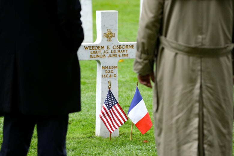 People pay respect at a tomb at the Aisne-Marne American Cemetery and Memorial in Belleau, on November 10, 2018.